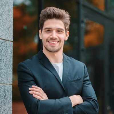 portrait-of-young-successful-confident-businessman-in-the-city-on-office-building-background-man-in_t20_AlnLA0-e1595815123529.jpg